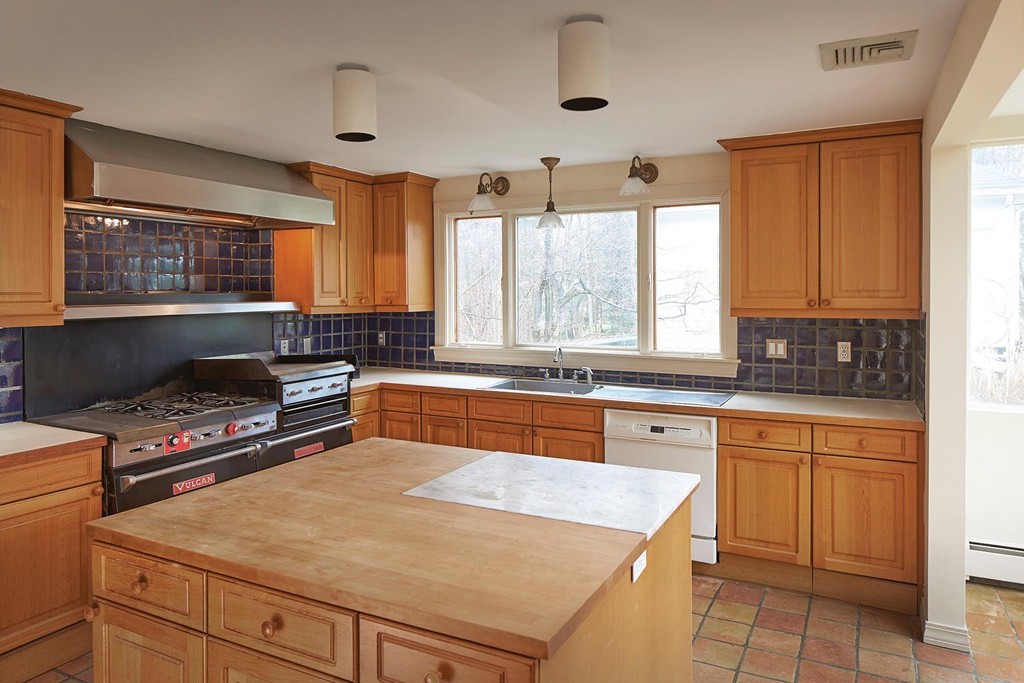 115 Windermere Road Newton, MA 02466 - Photo 3 of 8 a kitchen with stainless steel appliances granite countertop a stove a sink and a refrigerator