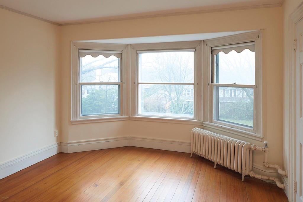 115 Windermere Road Newton, MA 02466 - Photo 6 of 8 a view of an empty room with wooden floor and a window