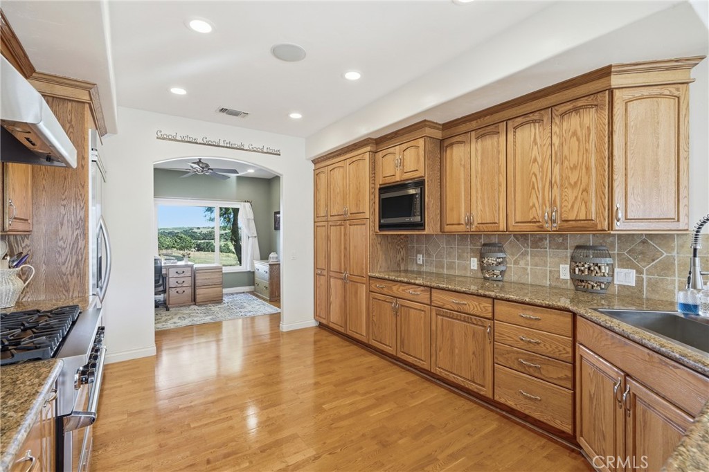 220 Cook Court Templeton, CA 93465 - Photo 14 of 45 a large kitchen with stainless steel appliances granite countertop a lot of counter space and wooden floor