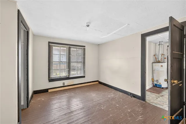 wooden floor in an empty room with a window