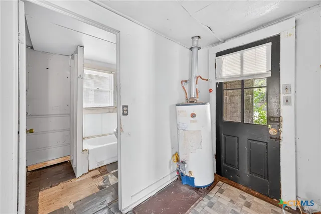 a view of a storage & utility room with closet window