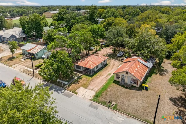 an aerial view of a house with a yard