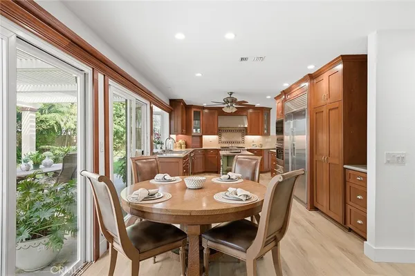 a kitchen with a stove a refrigerator and dining table