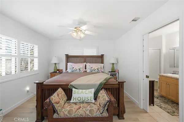 a bed room with a bed and a painting on the wall