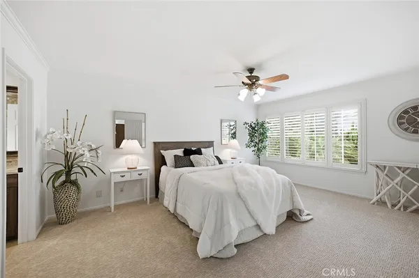 a bedroom with furniture and a large window