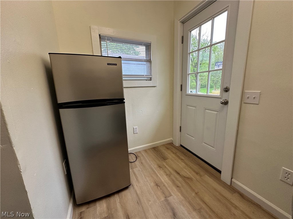 119 Shields Road, Unit 3 Youngstown, OH 44512 - Photo 9 of 12 Doorway with light wood-style flooring and baseboards