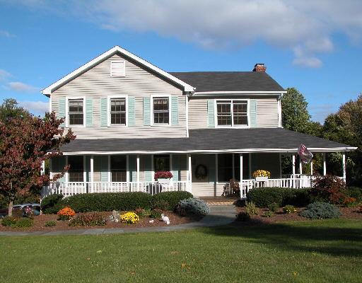 3 Patriot Ridge Road Newtown, CT 06482 - Photo 1 of 1 a front view of a house with a yard