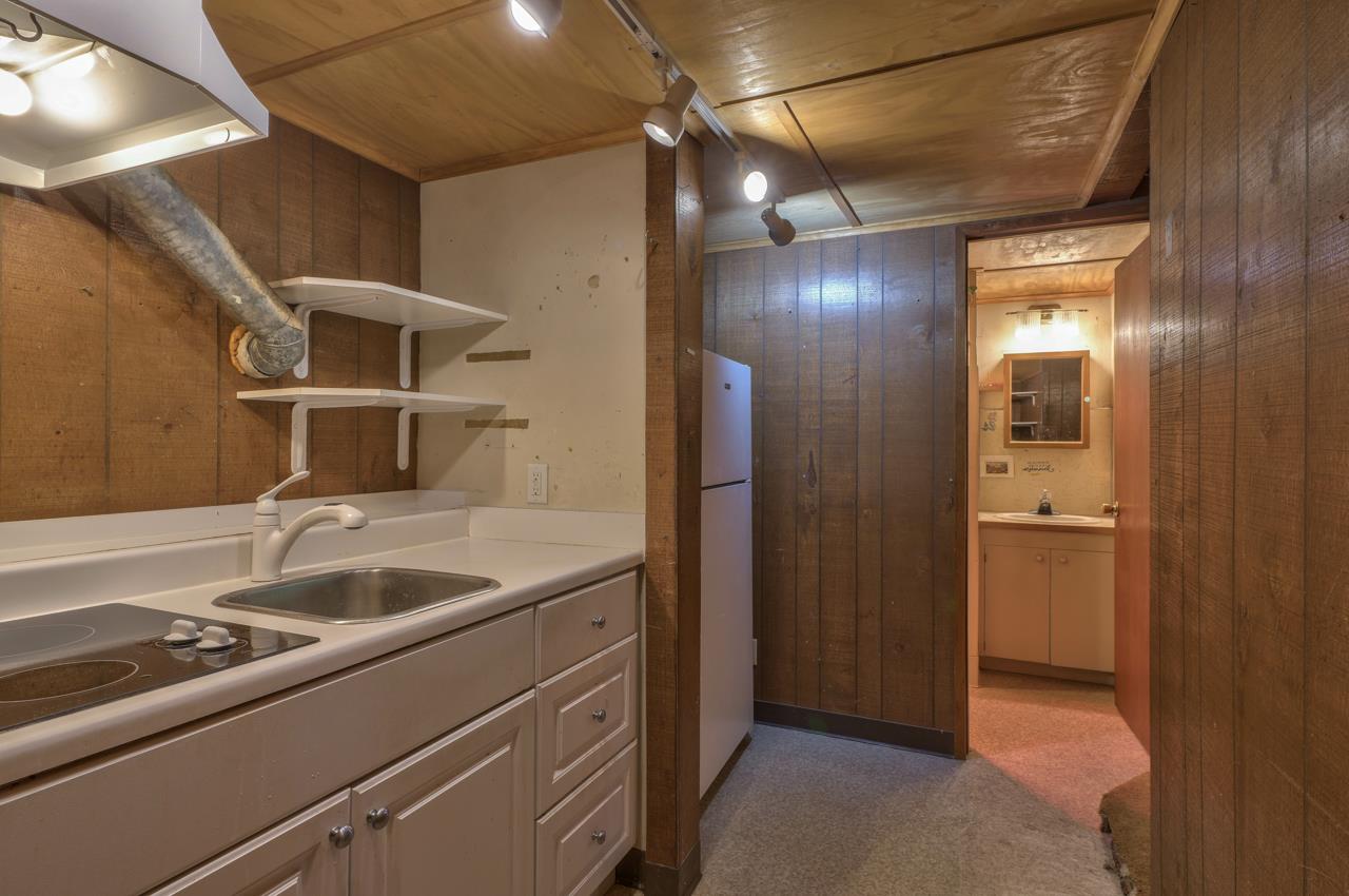 3245 Cabrillo Road Pebble Beach, CA 93953 - Photo 49 of 59 a kitchen with a sink and refrigerator