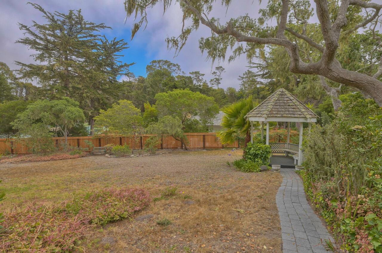 3245 Cabrillo Road Pebble Beach, CA 93953 - Photo 55 of 59 a front view of a house with a yard and garage
