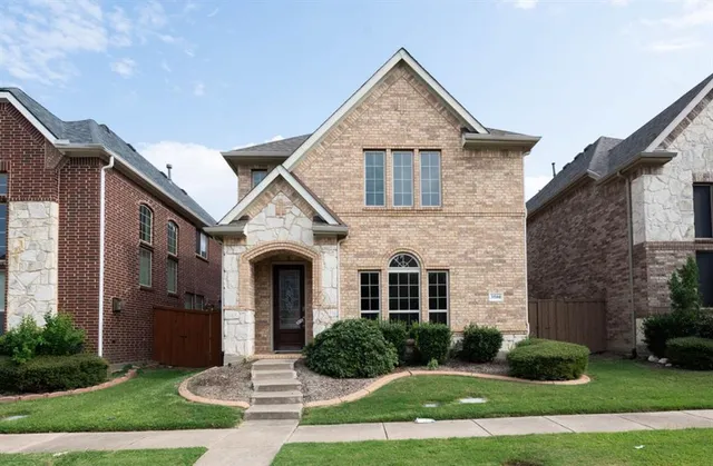 a front view of a house with yard and garage