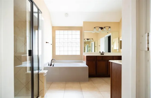 a spacious bathroom with a bathtub and a sink