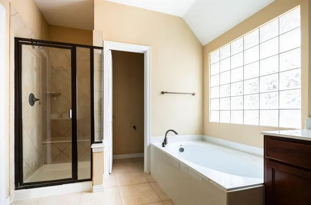 a bathroom with a bathtub and a shower