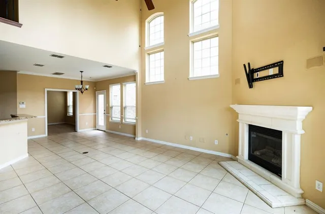 a view of a livingroom with a fireplace and window