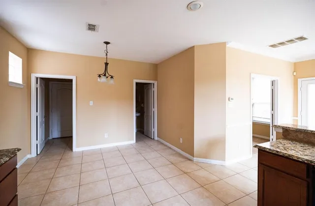 a view of a kitchen with a sink and a refrigerator mirror and window