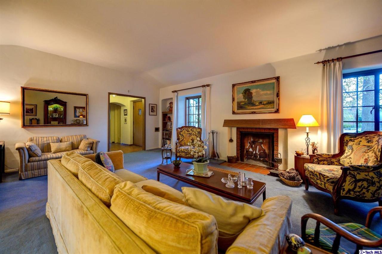 1271 Roanoke Road San Marino, CA 91108 - Photo 16 of 65 a living room with furniture large window and a fireplace