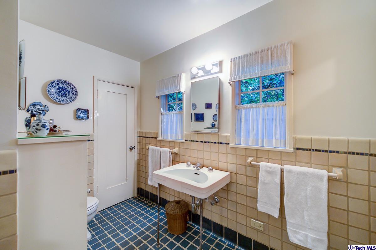 1271 Roanoke Road San Marino, CA 91108 - Photo 41 of 65 a bathroom with a sink a mirror and a toilet