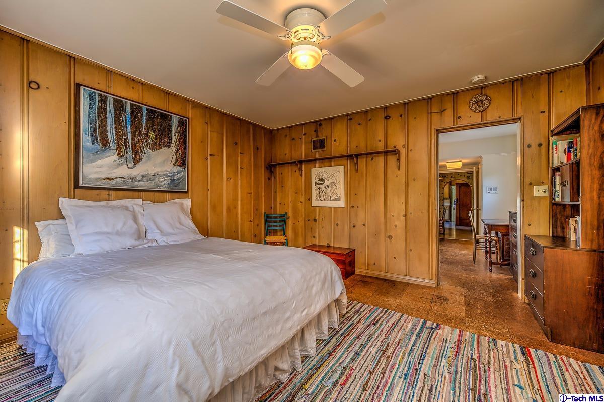 1271 Roanoke Road San Marino, CA 91108 - Photo 44 of 65 a spacious bedroom with a bed and a chandelier