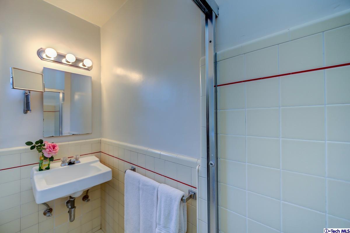 1271 Roanoke Road San Marino, CA 91108 - Photo 49 of 65 a bathroom with a sink vanity and a mirror