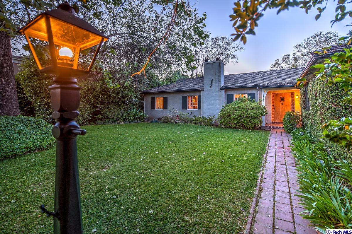 1271 Roanoke Road San Marino, CA 91108 - Photo 6 of 65 a front view of yellow house with a yard and potted plants