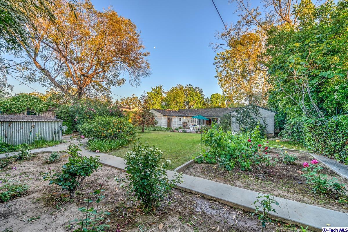 1271 Roanoke Road San Marino, CA 91108 - Photo 59 of 65 a front view of a house with a yard and fountain in middle