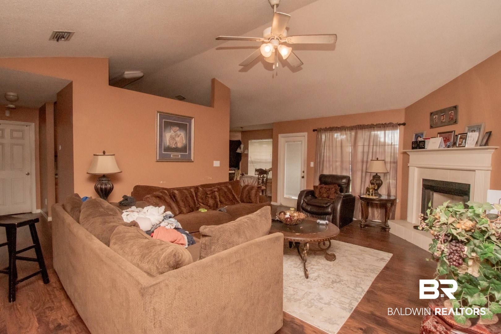 1537 Hunters Ridge Drive West Mobile, AL 36695 - Photo 4 of 12 Living room featuring dark hardwood / wood-style floors, vaulted ceiling, ceiling fan, and a tile fireplace