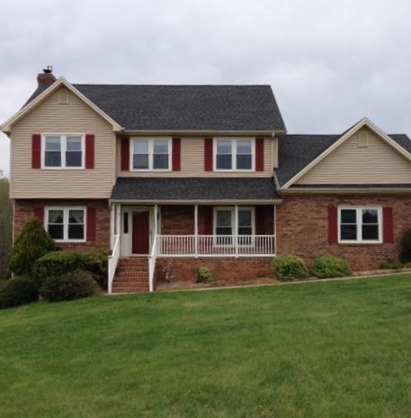 219 Longhill Road Goode, VA 24556 - Photo 1 of 15 a front view of a house with garden