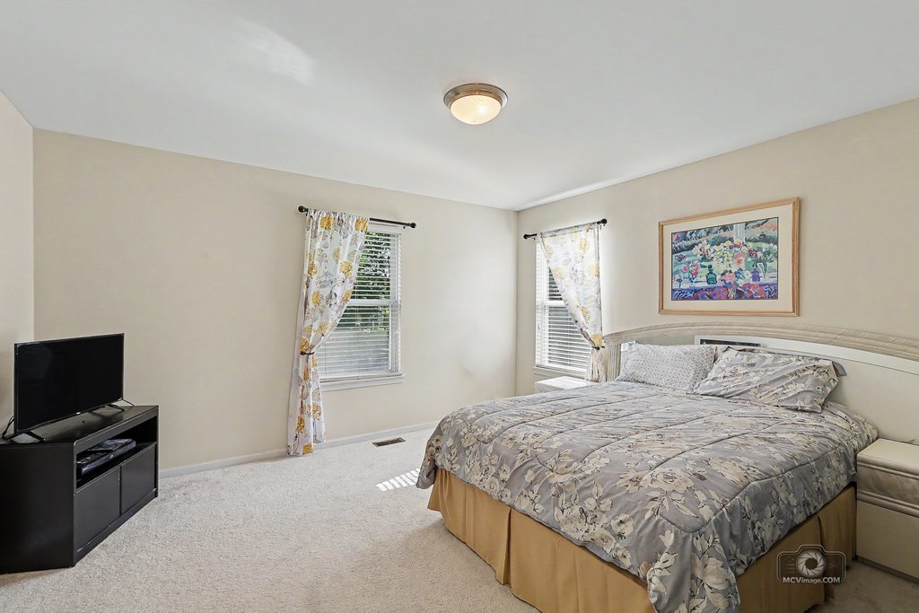 483 Elm Ridge Road Carpentersville, IL 60110 - Photo 18 of 31 a bedroom with a bed and a television in it