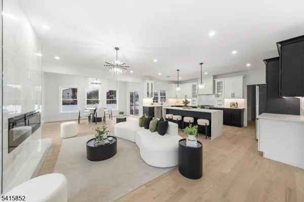 a living room with furniture and kitchen view