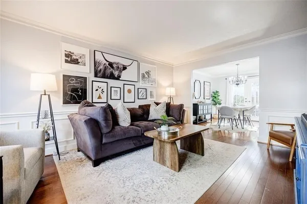 a living room with furniture and a wooden floor