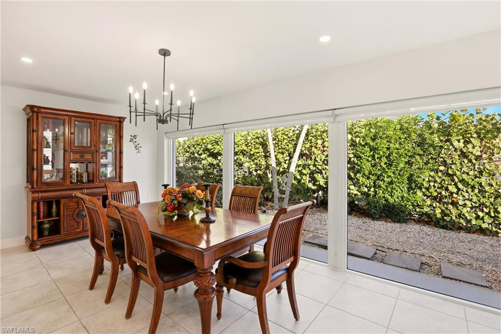 339 Landmark Street Marco Island, FL 34145 - Photo 19 of 50 Dining room featuring recessed lighting, light tile patterned floors, and a chandelier