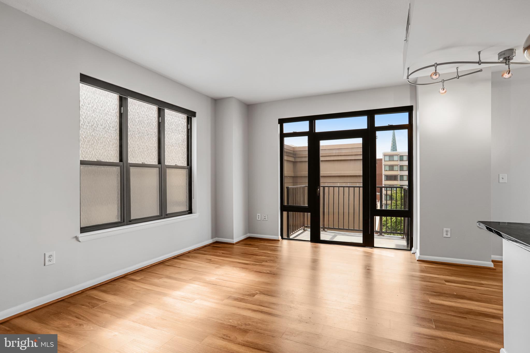 1001 L Street Northwest, Unit 811 Washington, DC 20001 - Photo 11 of 45 wooden floor in an empty room with a window