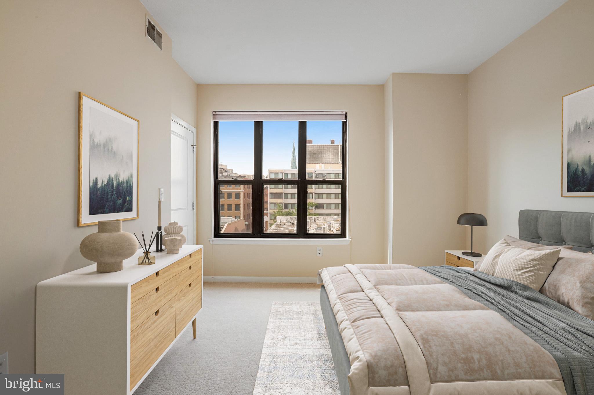 1001 L Street Northwest, Unit 811 Washington, DC 20001 - Photo 16 of 45 a bedroom with a bed and a large window