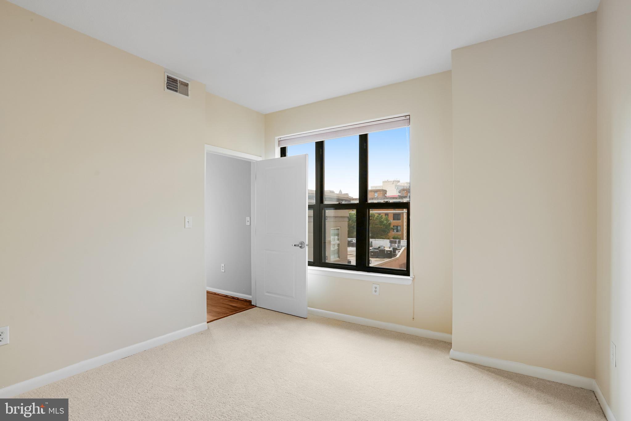 1001 L Street Northwest, Unit 811 Washington, DC 20001 - Photo 20 of 45 an empty room with windows and closet