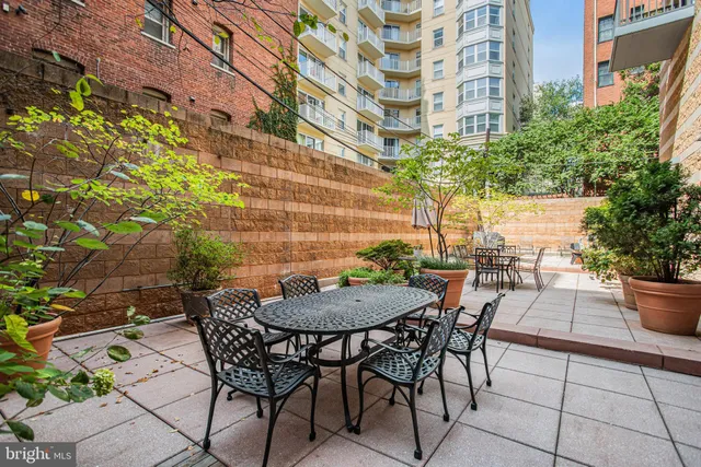 a view of a patio with table and chairs and potted plants