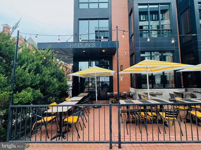 a view of a patio with a table and chairs under an umbrella