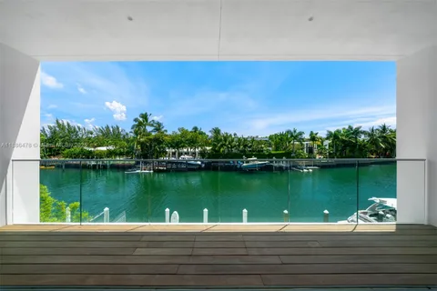 a living room with furniture potted plant and a large window