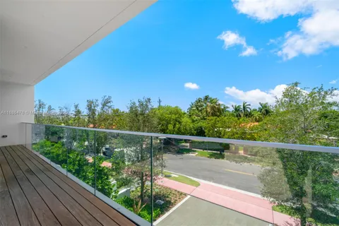 a view of a patio with couches table and chairs and potted plants