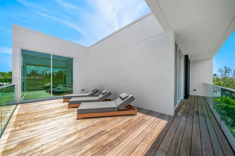a living room with furniture a flat screen tv and a floor to ceiling window