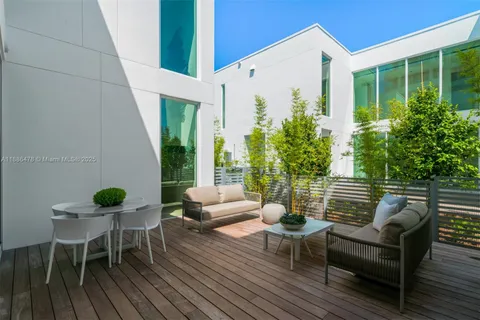 a view of house with swimming pool and outdoor seating