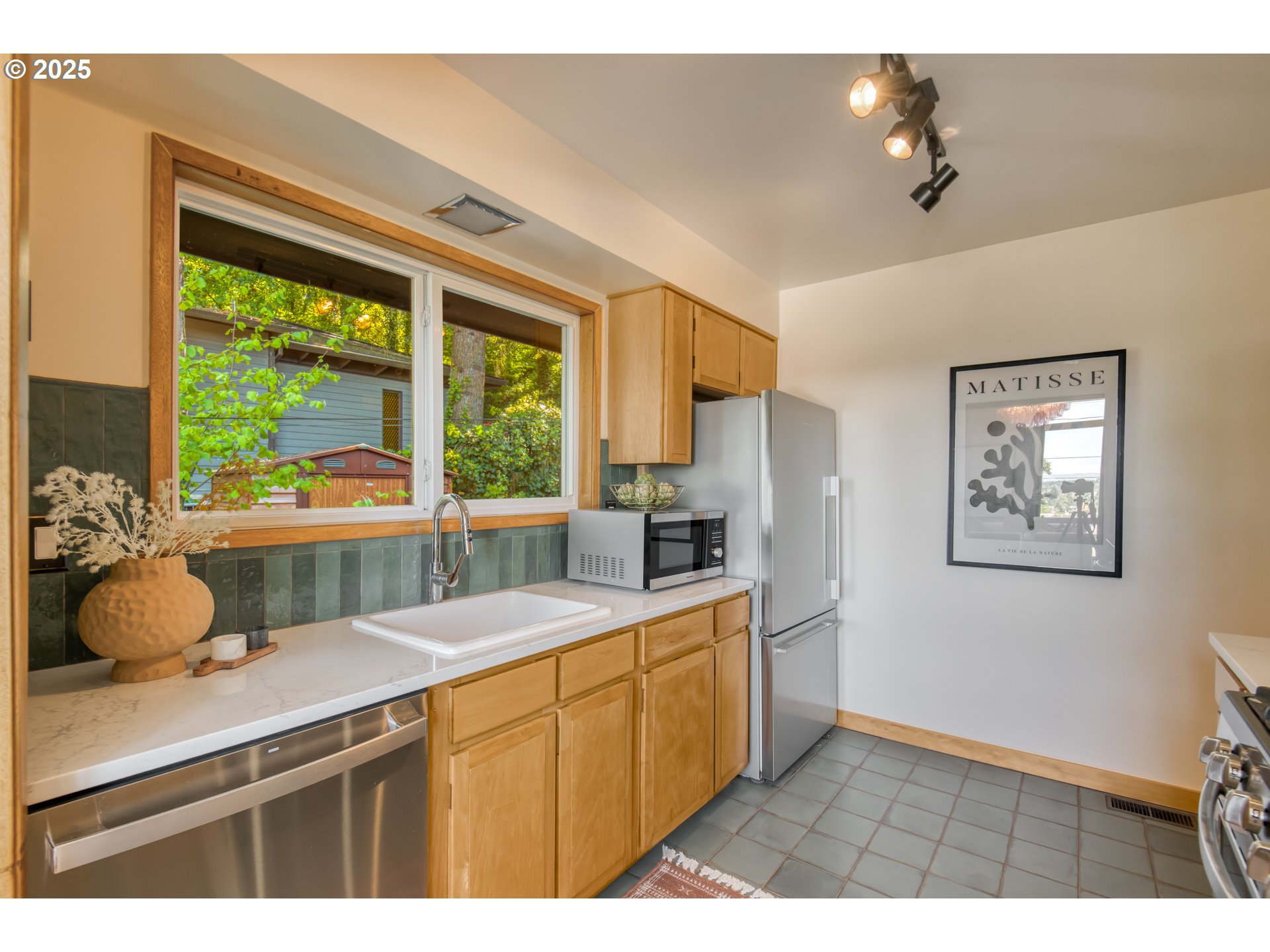 6950 Southeast Ash Street Portland, OR 97215 - Photo 12 of 45 a kitchen with a sink appliances and a window