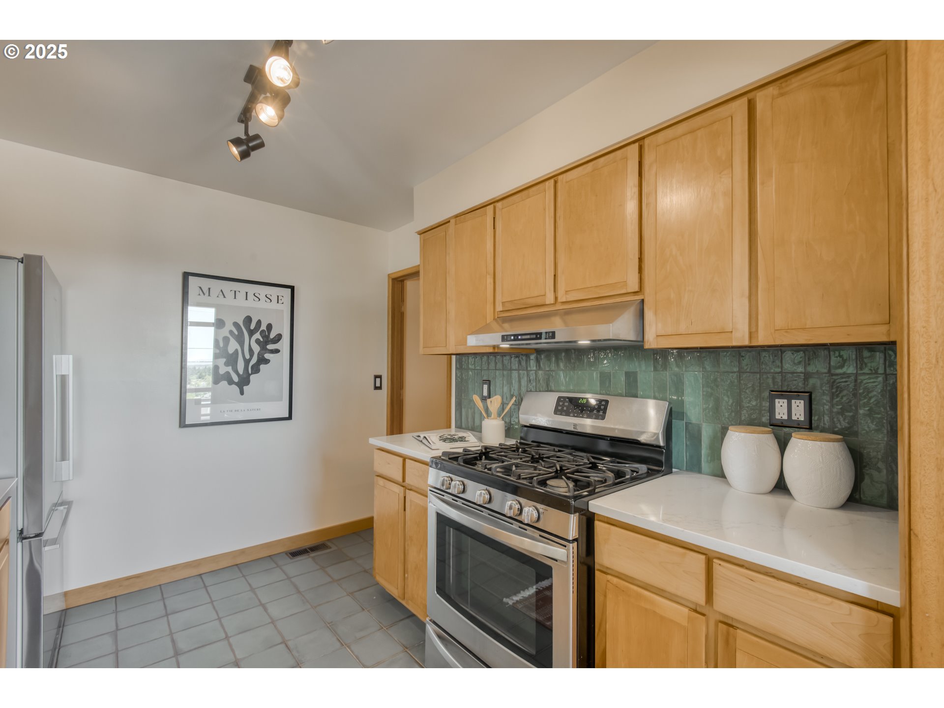 6950 Southeast Ash Street Portland, OR 97215 - Photo 13 of 45 a kitchen with stainless steel appliances granite countertop a stove a sink and a microwave
