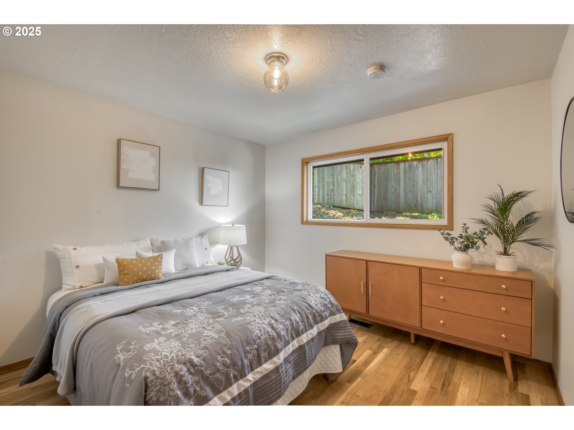 6950 Southeast Ash Street Portland, OR 97215 - Photo 18 of 45 a bedroom with a bed and a dresser