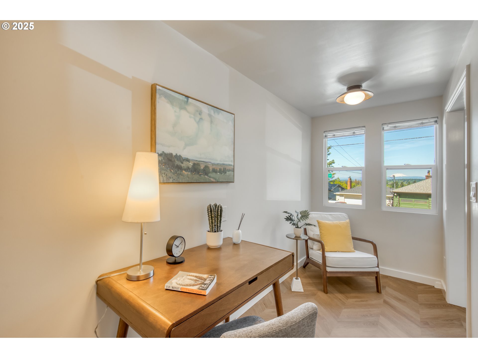 6950 Southeast Ash Street Portland, OR 97215 - Photo 29 of 45 a living room with a table and a potted plant