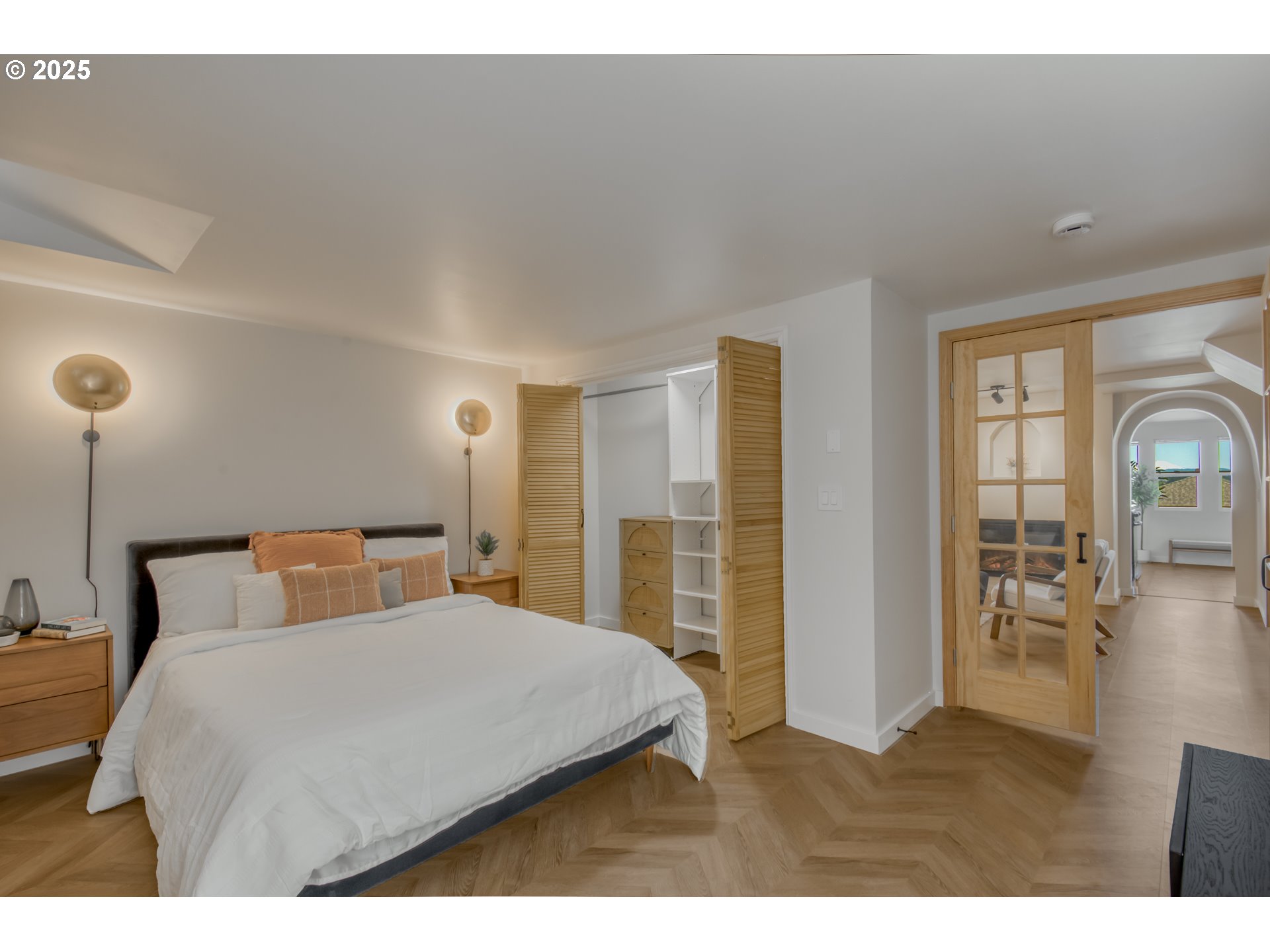 6950 Southeast Ash Street Portland, OR 97215 - Photo 31 of 45 a bedroom with a large bed and a chandelier