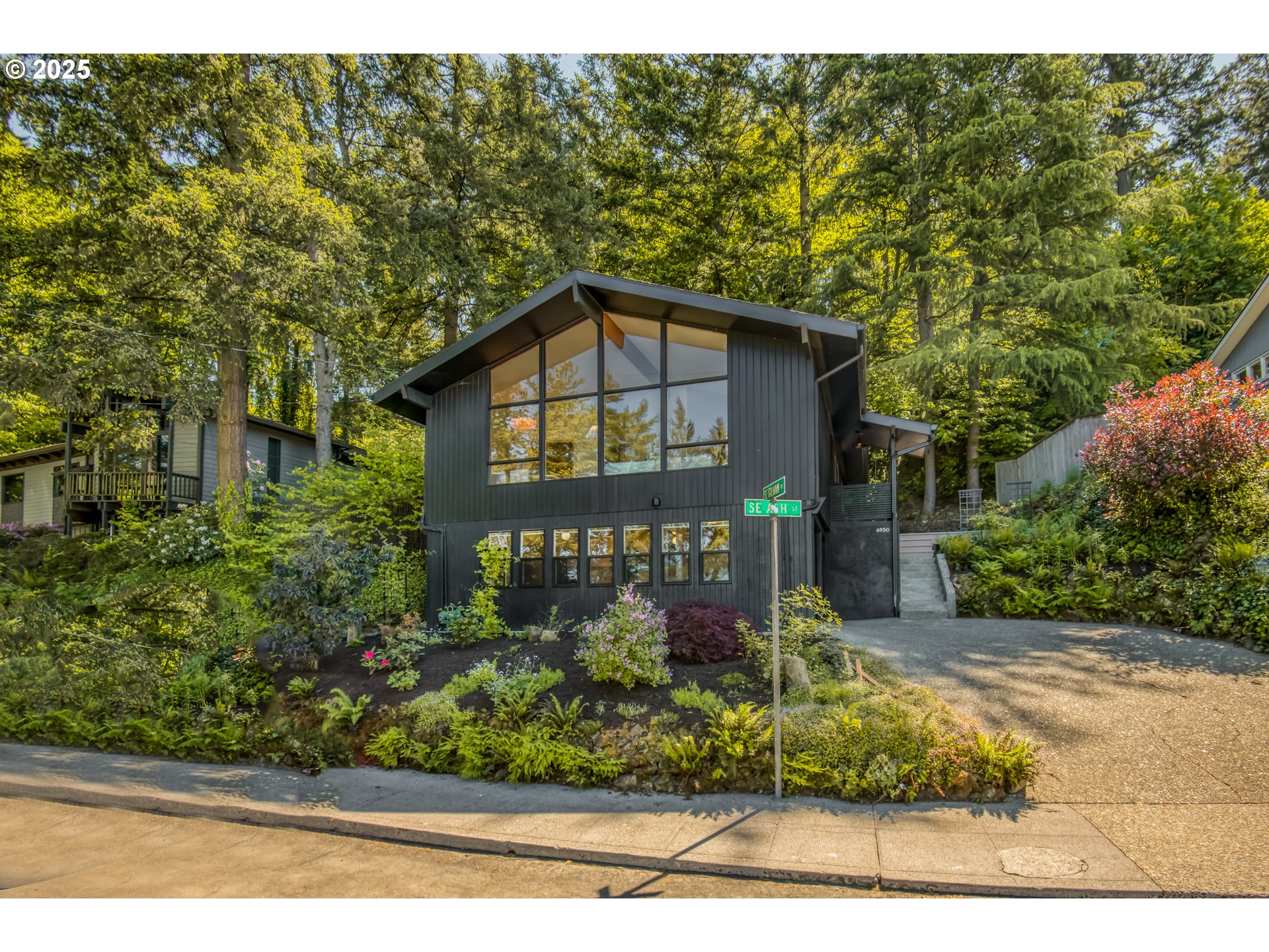 6950 Southeast Ash Street Portland, OR 97215 - Photo 43 of 45 a front view of a house with garden