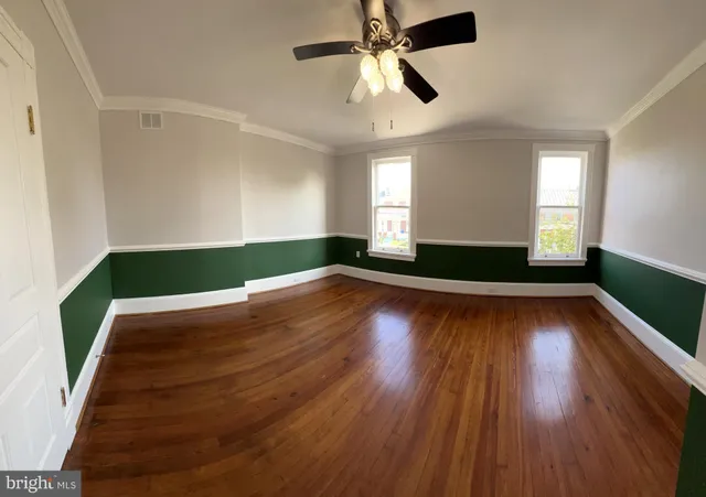 a view of room with window and wooden floor