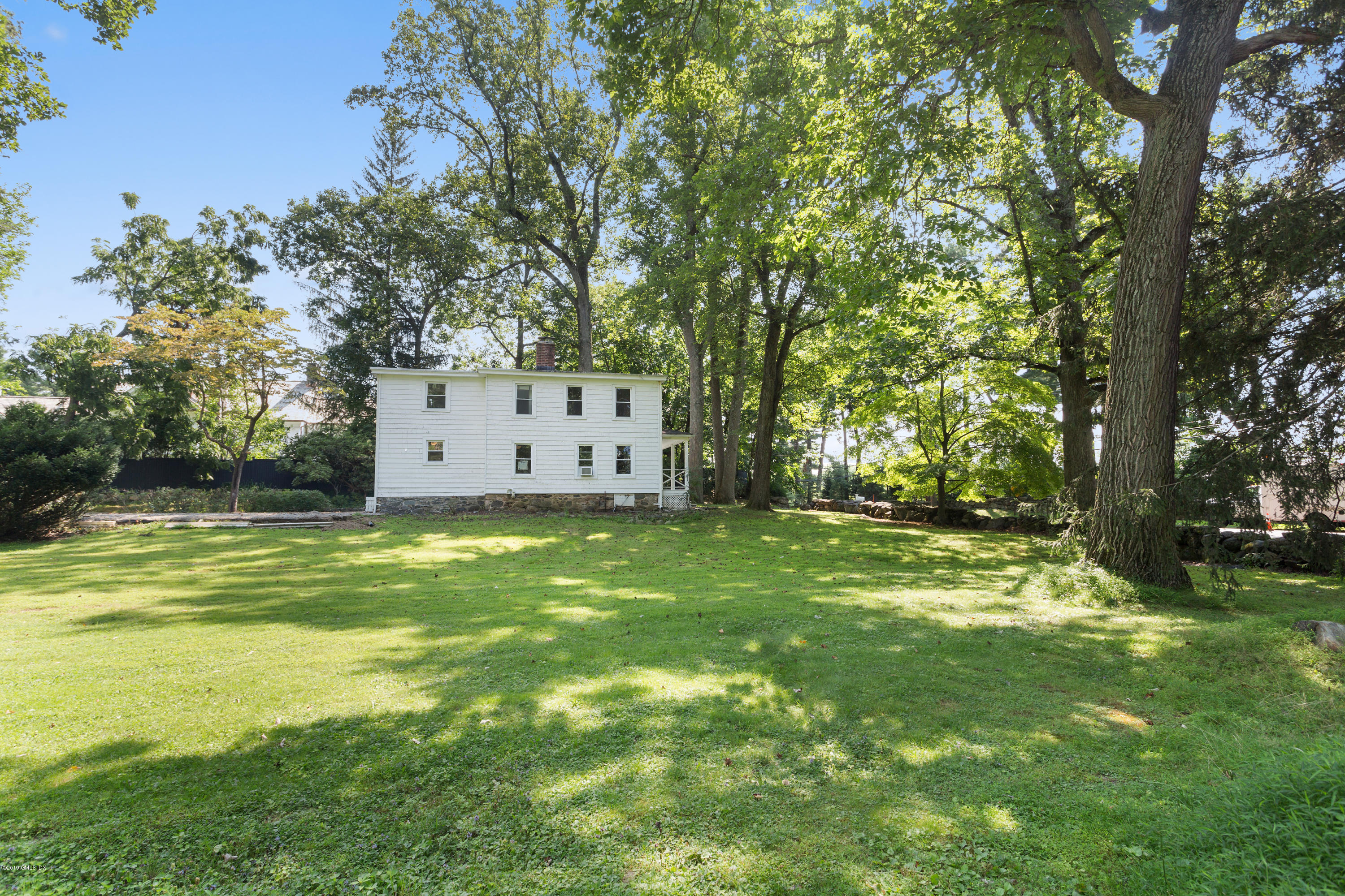 33 Parsonage Road Greenwich, CT 06830 - Photo 11 of 11 a view of a backyard with large trees