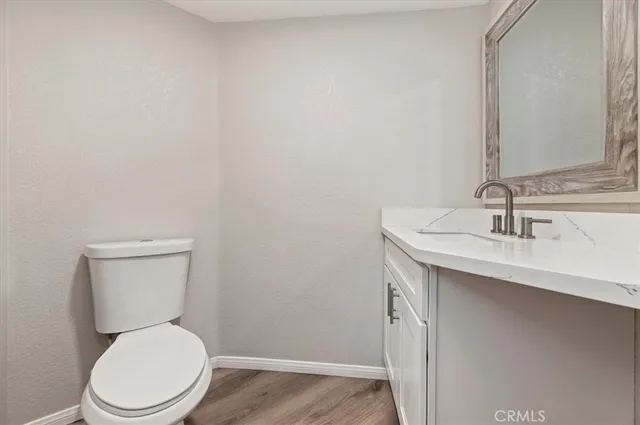 a white toilet sitting next to a bathroom sink