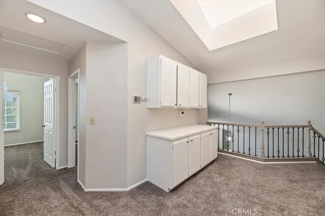 an empty room with windows and fireplace