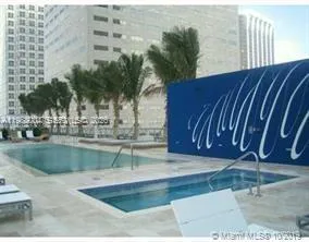 a swimming pool with outdoor seating and a garden